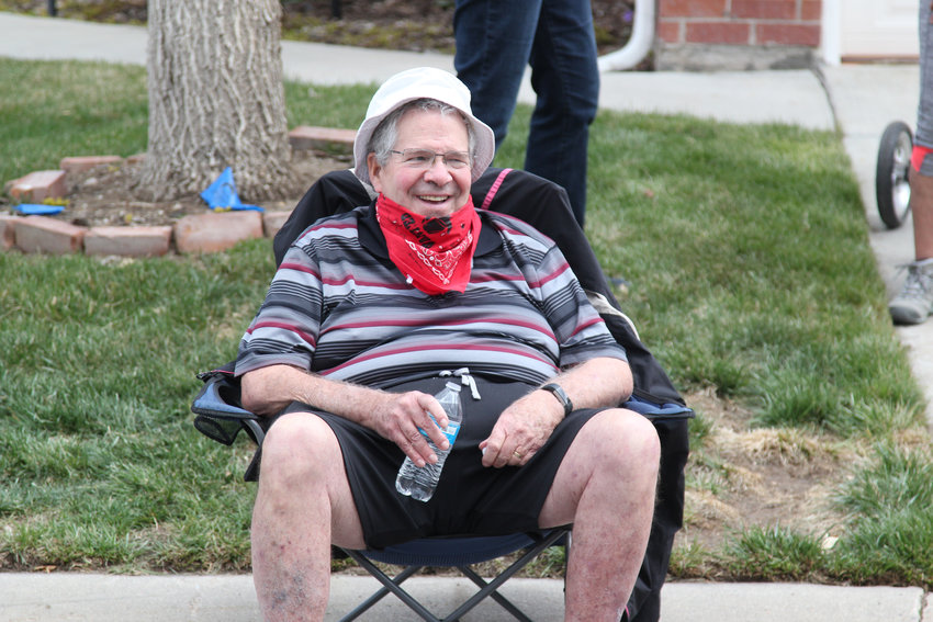 Neighbor John Robbins set up a lawn chair to watch the parade for Evelyn Berkey on her 100th birthday.